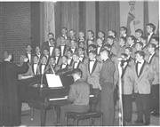 Brother Harold Frank, FSC, leads the men's choral group during the 1967 Showcase.